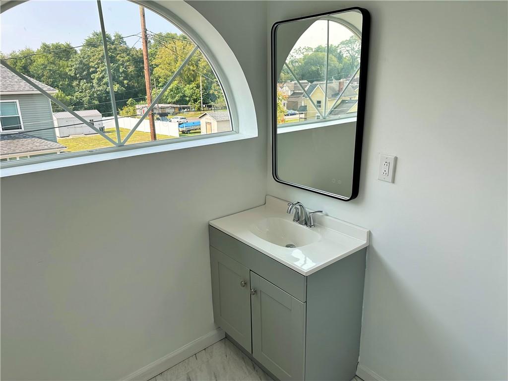 308 West Cherry Street New Castle, PA 16102 - Photo 24 of 25 a bathroom with a sink and a mirror