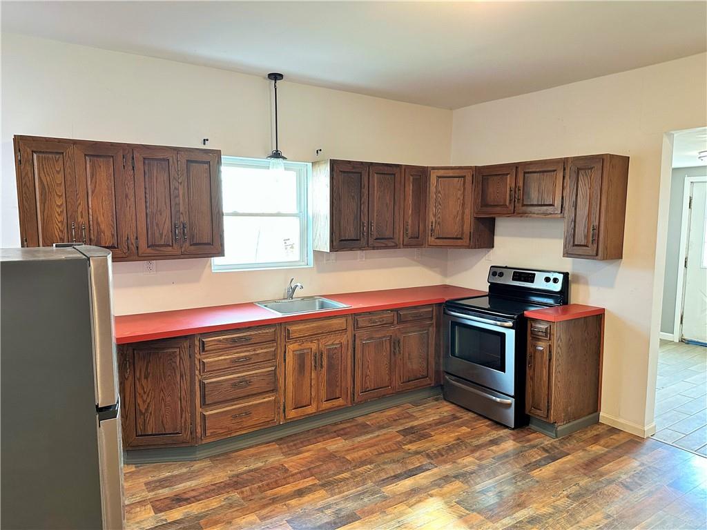 308 West Cherry Street New Castle, PA 16102 - Photo 9 of 25 a kitchen with stainless steel appliances granite countertop a stove a sink dishwasher and a refrigerator with wooden cabinets