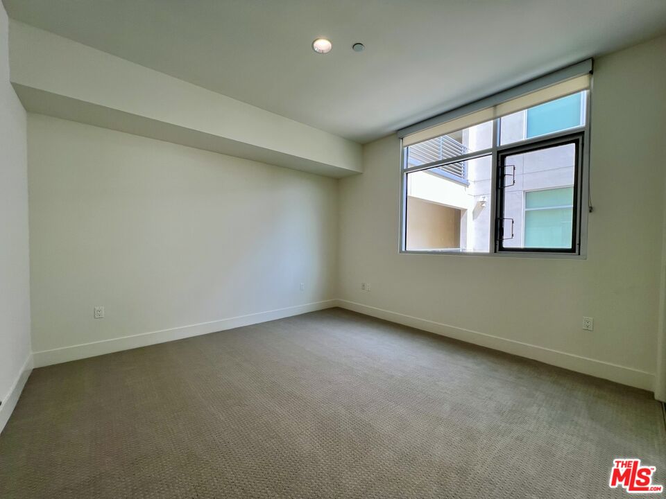 11715 Bellagio Road, Unit 204 Los Angeles, CA 90049 - Photo 13 of 27 an empty room with a window
