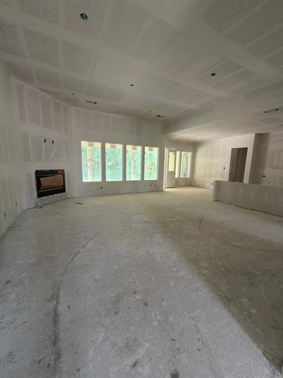1003 Perrin Lane Van Alstyne, TX 75495 - Photo 9 of 18 a view of an empty room with a fireplace and a window