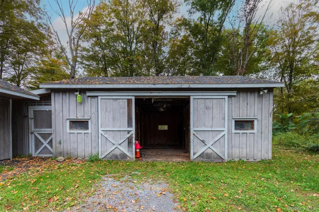 a view of a house with a yard and wooden fence
