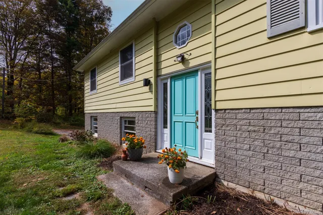 a view of a backyard with plants and outdoor seating