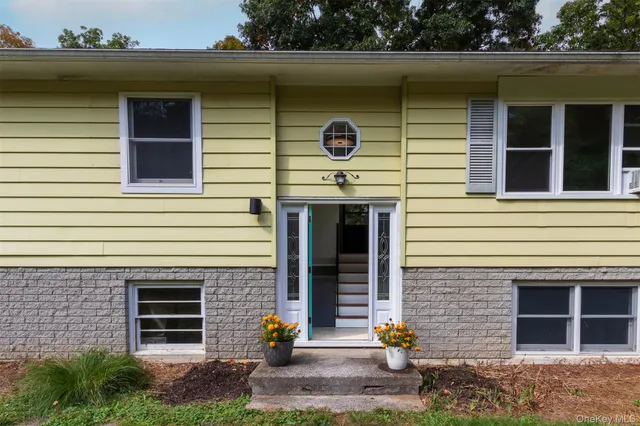 a front view of a house with plants