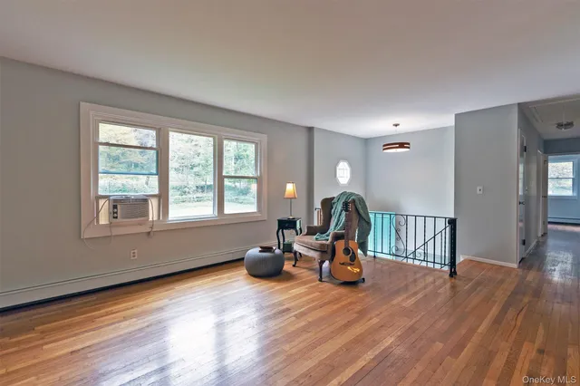 a view of a room with wooden floor furniture and windows