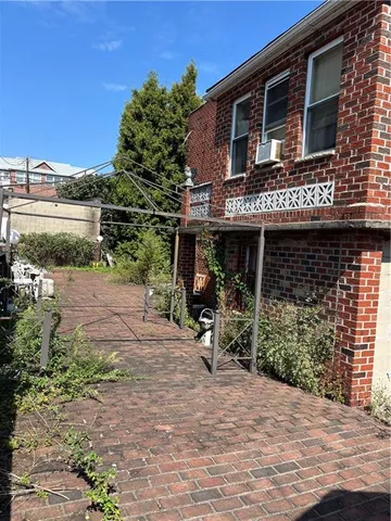a front view of a house with garden and porch