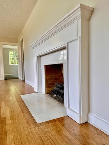 a view of an empty room and wooden floor