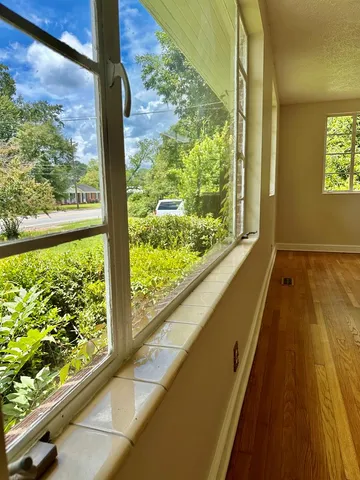 a view of a room with wooden floor and windows