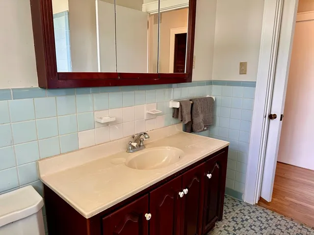 a bathroom with a sink vanity and a mirror