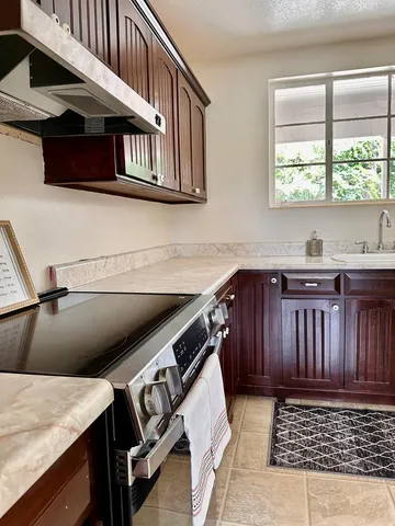 a kitchen that has a sink and a stove