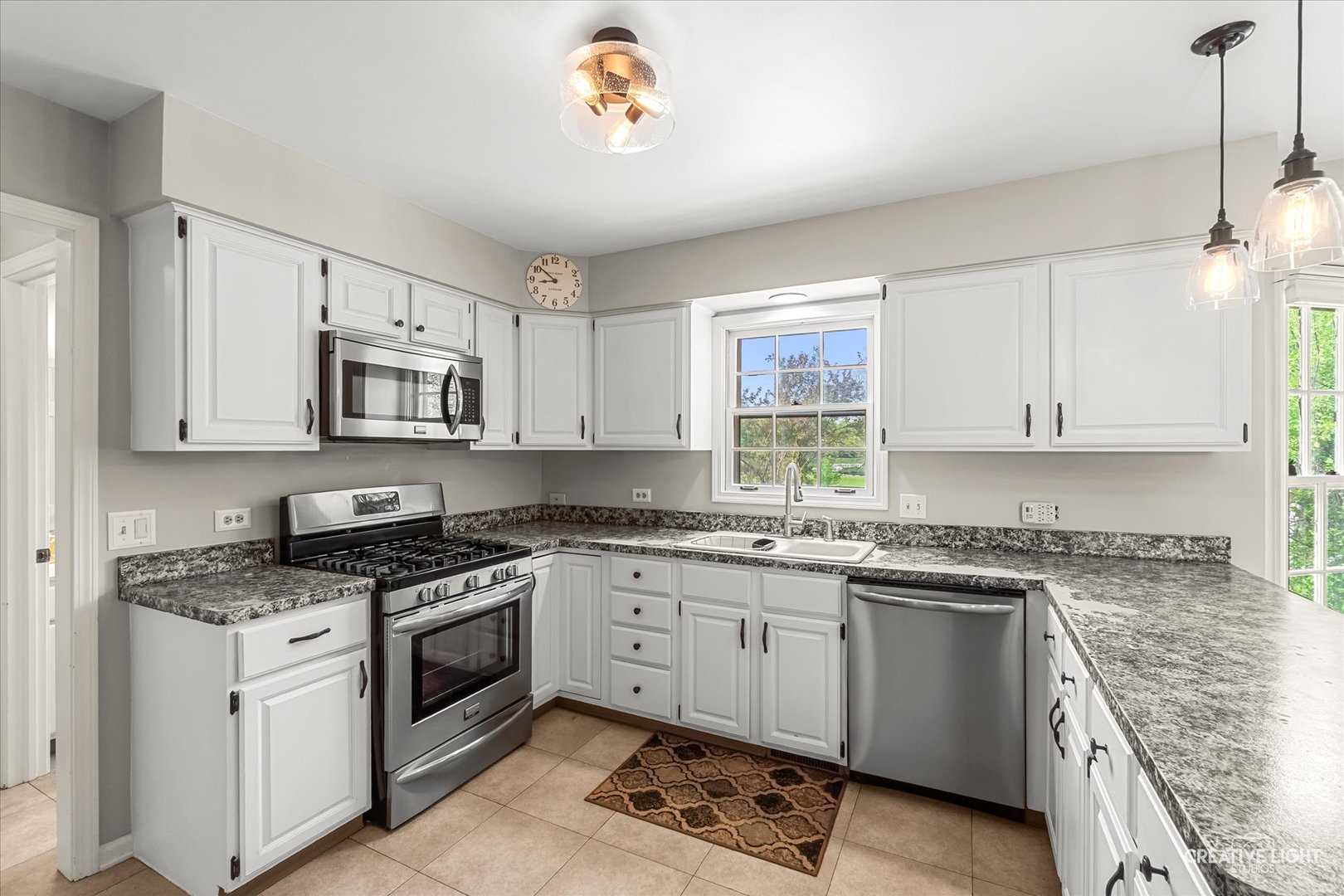 27W343 Churchill Road Winfield, IL 60190 - Photo 8 of 40 a kitchen with white cabinets appliances and a window