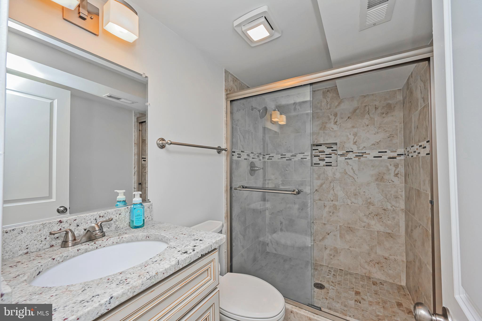 5310 Danbury Forest Drive Springfield, VA 22151 - Photo 24 of 42 Remodeled Lower Bath with White Vanity + Granite