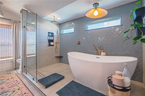 a spacious bathroom with a tub and shower