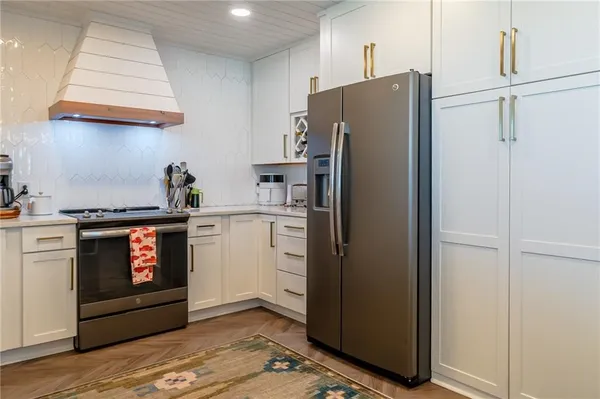 a kitchen with stainless steel appliances a refrigerator and a stove