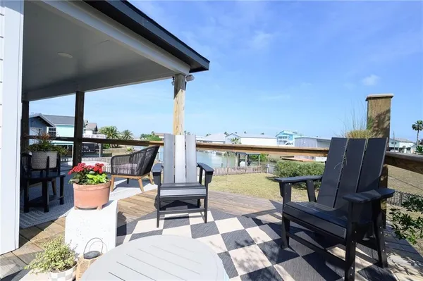 a balcony with chairs and wooden floor