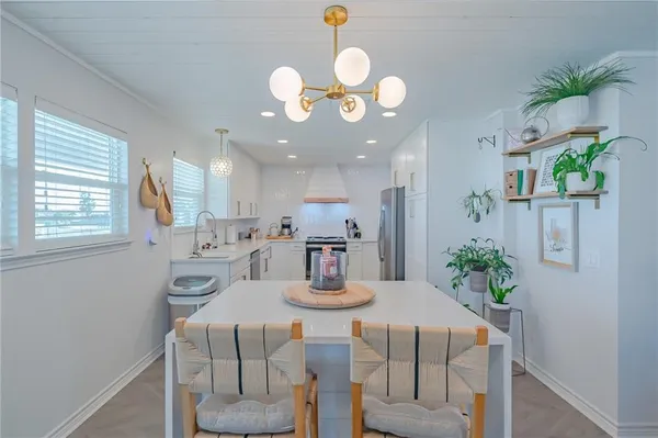 a kitchen with a table and chairs in it
