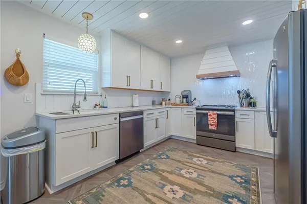 a kitchen with a sink cabinets and window