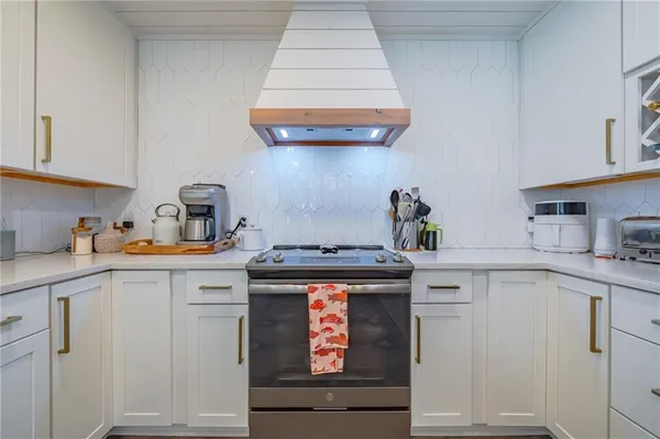 a kitchen with granite countertop a sink stainless steel appliances and cabinets