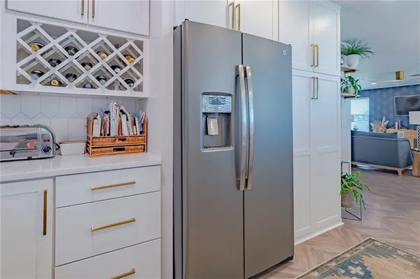 a kitchen with a refrigerator and cabinets