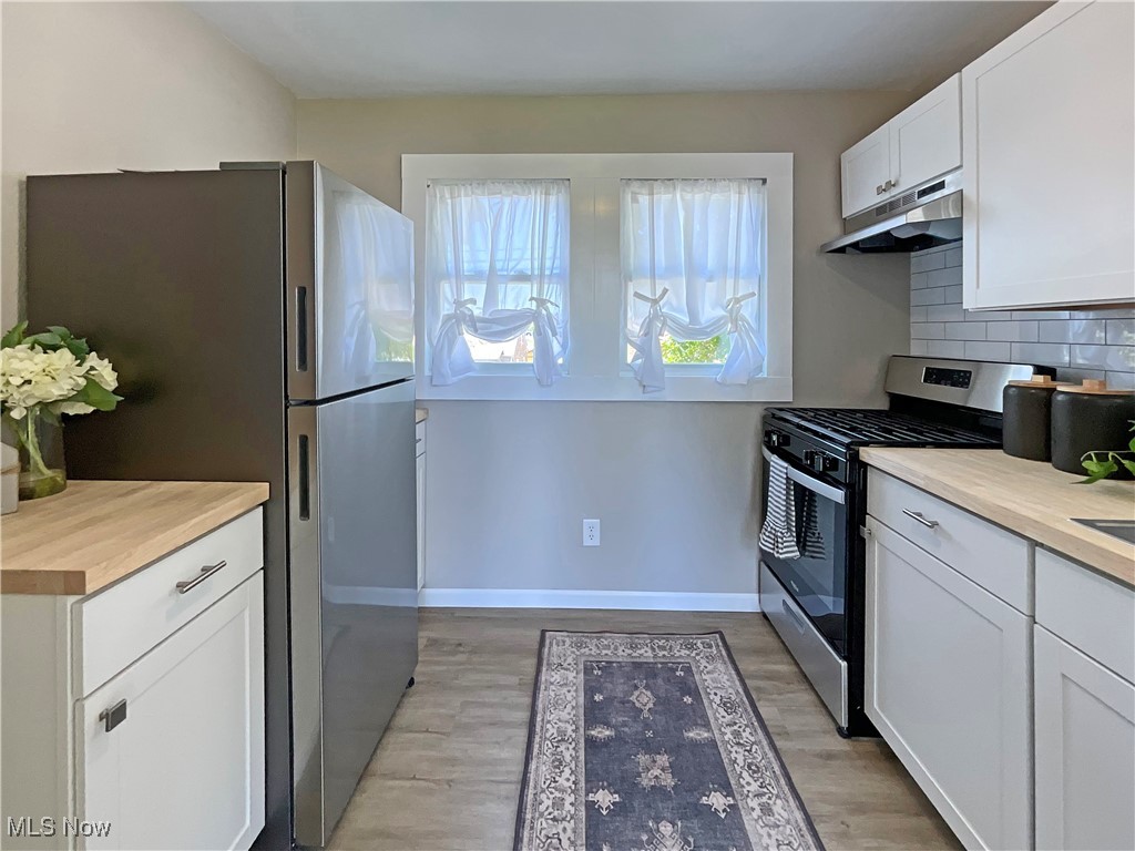 200 Ritchie Avenue Weirton, WV 26062 - Photo 8 of 30 Kitchen featuring butcher block countertops, white cabinetry, stainless steel appliances, and light hardwood / wood-style floors