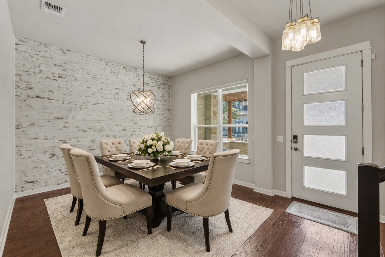 3919 Vaughan Street Austin, TX 78723 - Photo 8 of 40 A striking dining room features a distressed shiplap accent wall, perfectly complemented by rich hardwood flooring.