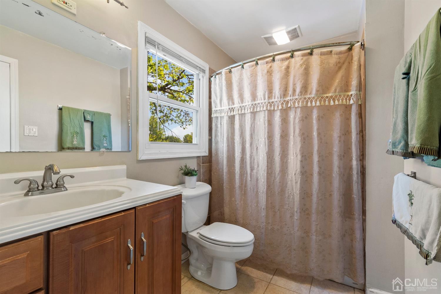 15 Tar Heels Road Hamilton, NJ 08619 - Photo 27 of 46 a bathroom with a sink a toilet and a mirror