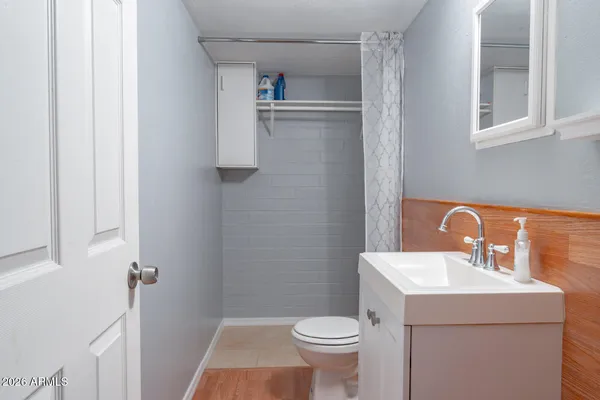 a bathroom with a sink toilet and shower