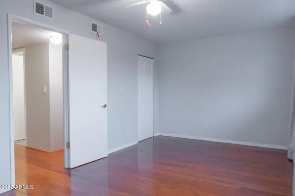 a view of a room with wooden floor