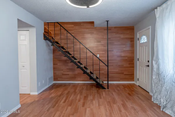 a view of entryway and hall with wooden floor