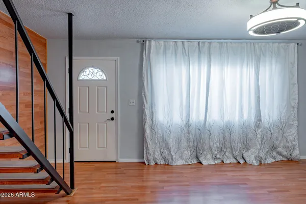 a view of an entryway with wooden floor and stairs