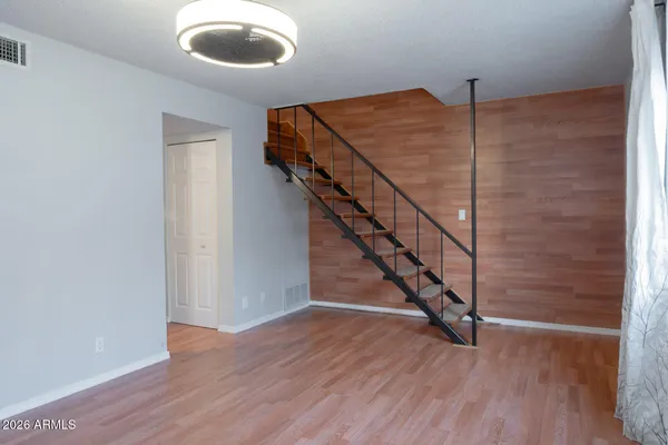 a view of entryway and hall with wooden floor