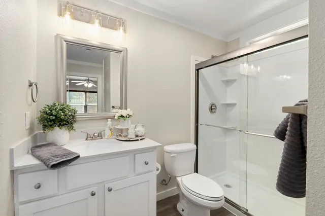 a bathroom with a sink toilet and shower