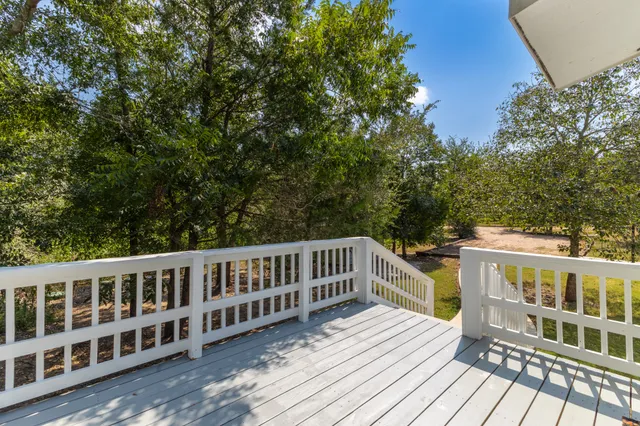 a view of a wooden deck and a yard