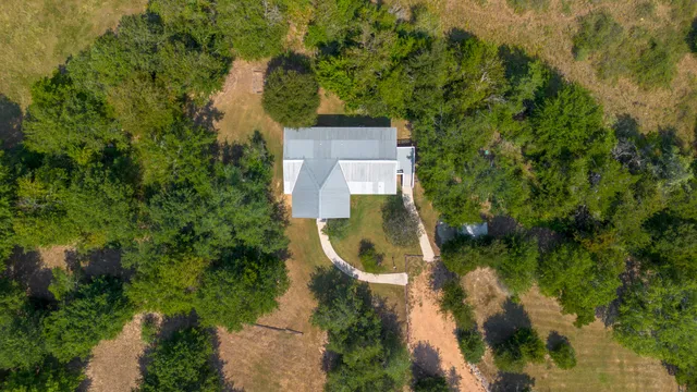 an aerial view of a house with a yard