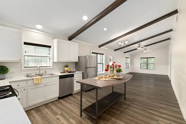 a kitchen filled a counter space a sink appliances and cabinets