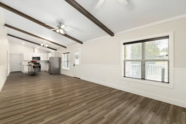 a view of empty room with wooden floor
