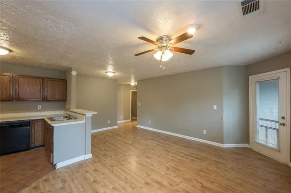 a view of a kitchen with a sink a refrigerator and a stove top oven