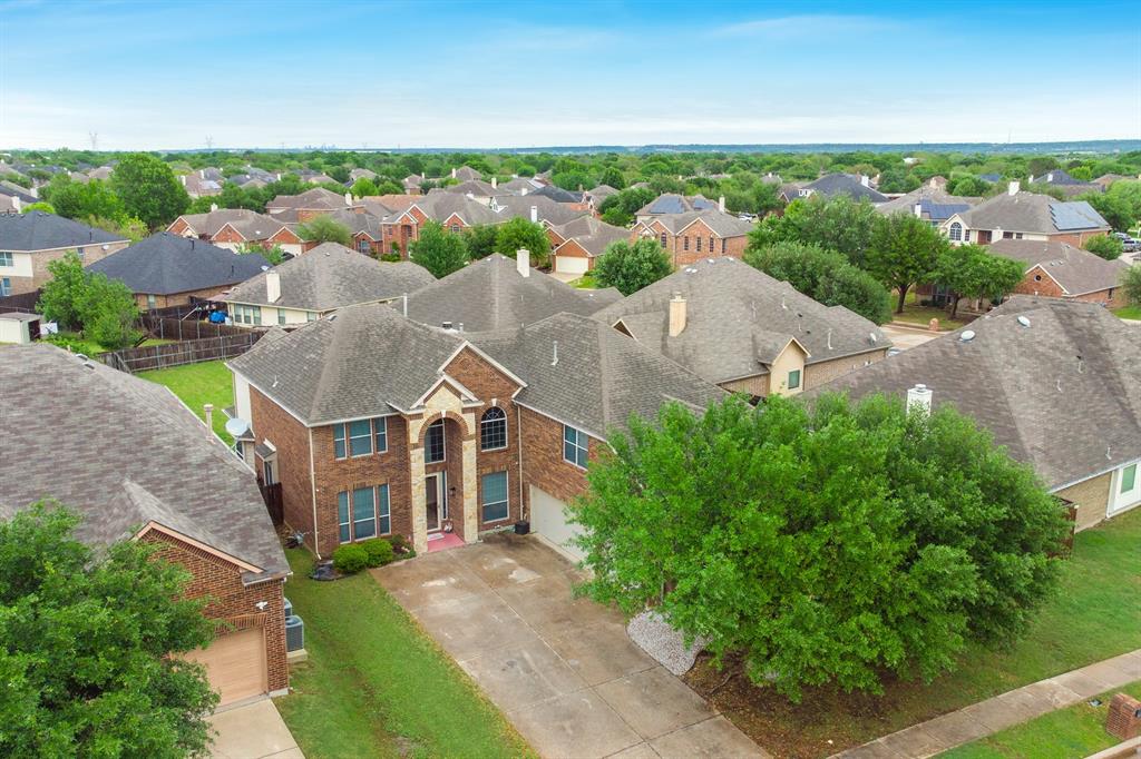 2312 Tawny Owl Road Grand Prairie, TX 75052 - Photo 40 of 40 Traditional two-story brick residence with multiple gables, an arched entry, and a paved driveway