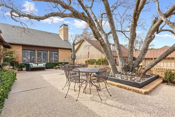 a view of a patio with table and chairs and potted plants