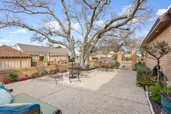 a view of a patio with table and chairs and potted plants