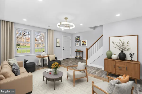 a living room with furniture potted plant and window