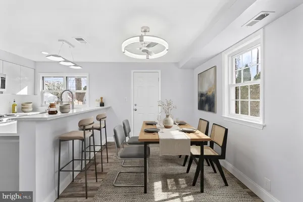a view of a dining room with furniture and a chandelier