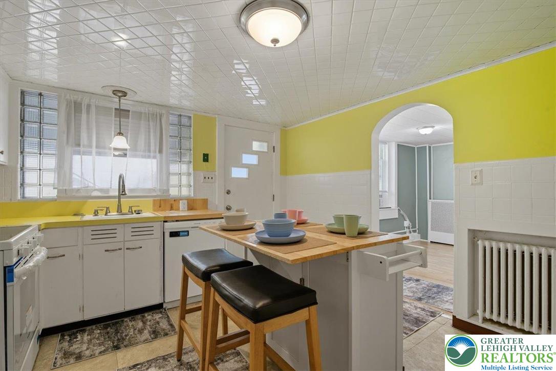 229 West High Street Nesquehoning, PA 18240 - Photo 12 of 38 a view of a kitchen area with furniture and wooden floor