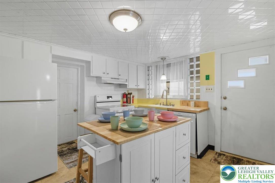 229 West High Street Nesquehoning, PA 18240 - Photo 13 of 38 a kitchen with a sink a stove cabinets and refrigerator