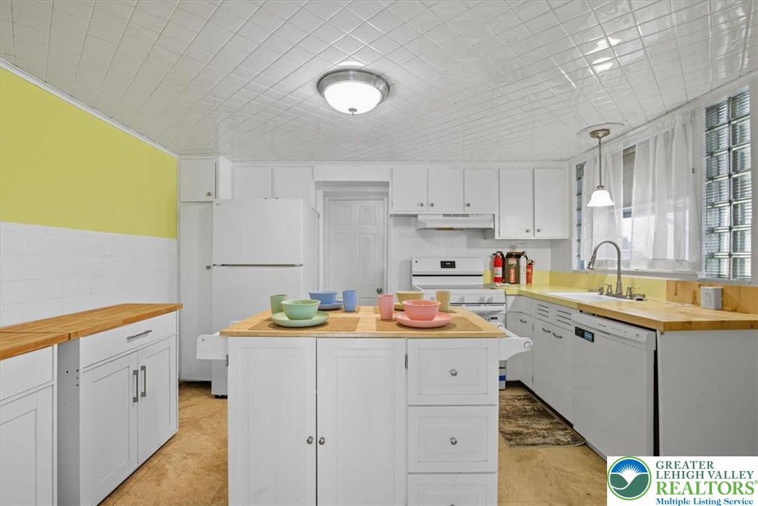 229 West High Street Nesquehoning, PA 18240 - Photo 14 of 38 a kitchen with stainless steel appliances granite countertop a sink stove and cabinets