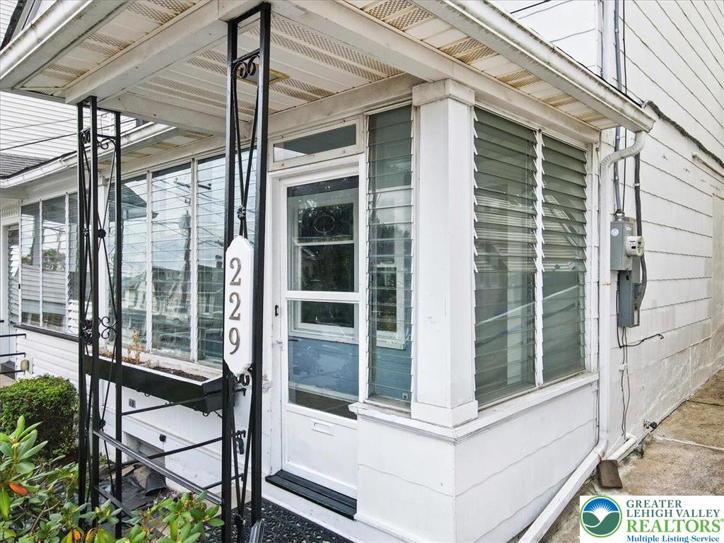 229 West High Street Nesquehoning, PA 18240 - Photo 3 of 38 a view of a balcony with a floor to ceiling window and wooden floor