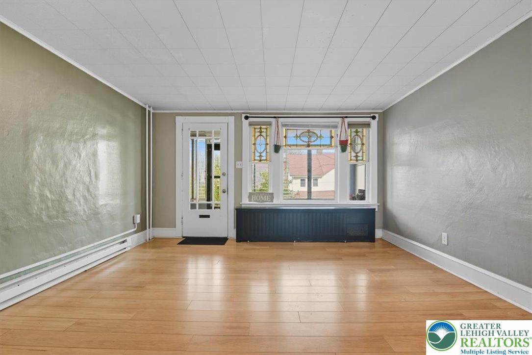 229 West High Street Nesquehoning, PA 18240 - Photo 6 of 38 wooden floor in an empty room with a window