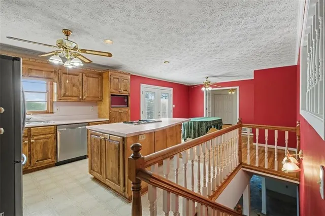 a kitchen with stainless steel appliances granite countertop a refrigerator and a sink