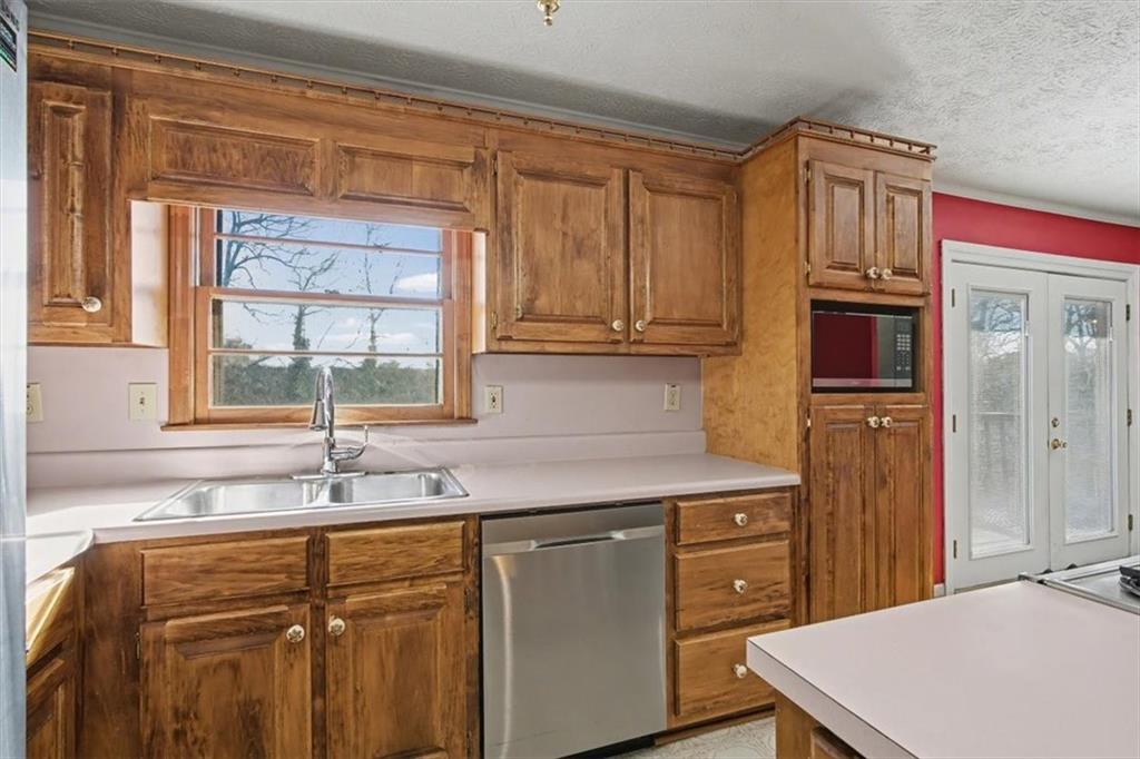 5 Ridgewood Drive Cartersville, GA 30120 - Photo 13 of 46 a kitchen with stainless steel appliances granite countertop a sink stove and refrigerator