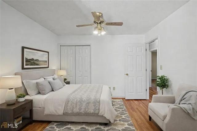 a view of a big room with wooden floor and windows