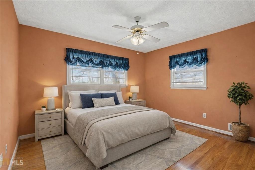 5 Ridgewood Drive Cartersville, GA 30120 - Photo 20 of 46 a bedroom with a large bed and a chandelier